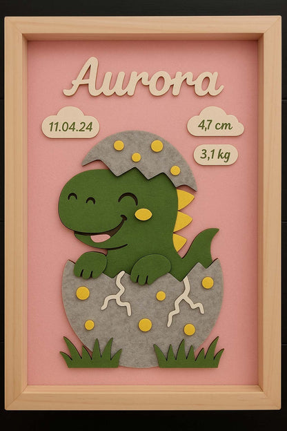Quadretto nascita rappresentante un dinosauro che sta nascendo. Sono presenti anche i dati del bambino per il quale il quadretto è fatto.