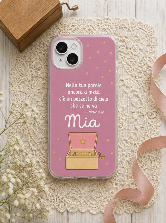 Cover per i nonni con un carillon di legno, frase di Victor Hugo e nome Mia, su un iPhone 15 visto dall'alto